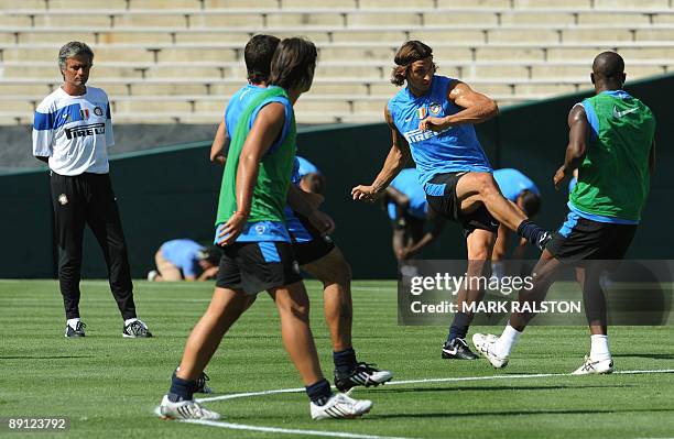 Inter Milan forward Zlatan Ibrahimovic kicks the ball as coach José Mourinho watches during training at the Rose Bowl on the eve of their game...