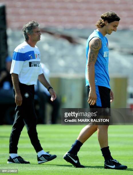 Inter Milan forward Zlatan Ibrahimovic smiles beside coach José Mourinho as they train at the Rose Bowl on the eve of their game against Chelsea, in...