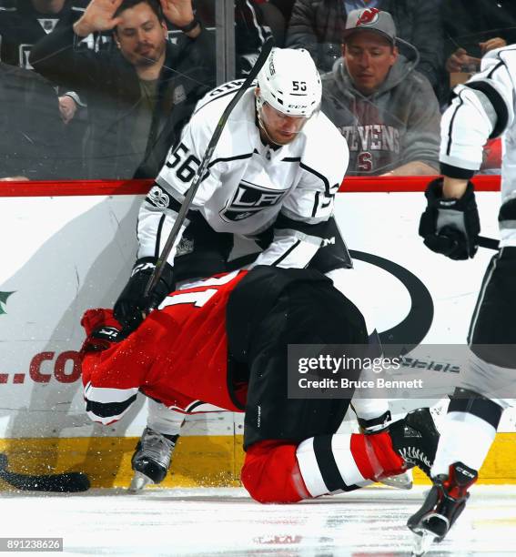 Kurtis MacDermid of the Los Angeles Kings hits Jimmy Hayes of the New Jersey Devils during the second period at the Prudential Center on December 12,...