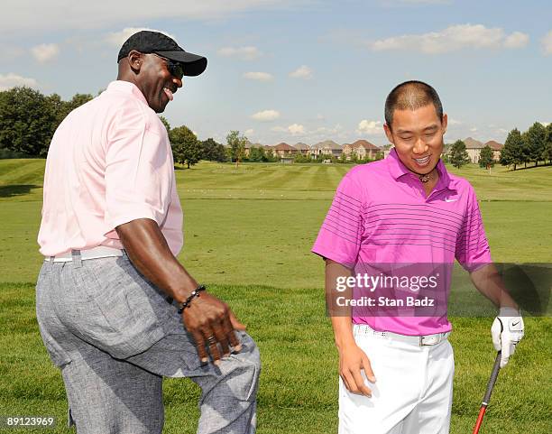 Five-time NBA MVP Michael Jordan and Anthony Kim joke on the practice range before the RBC Canadian Open's Mike Weir Charity Classic Pro-Am at Glen...