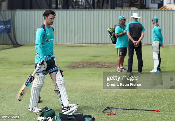 Peter Handscomb of Australia walks from the nets as Australian Head Coach Darren Lehmann, Australian Selector Greg Chappell and Steve Smith of...