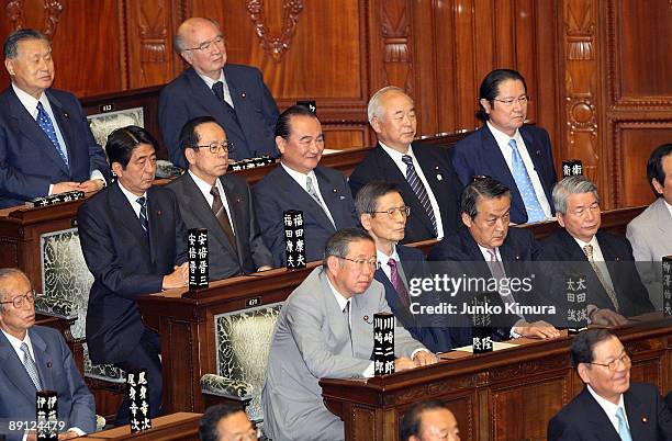 Former Prime Ministers Shinzo Abe and Yasuo Fukuda and other members of the House of Representatives attend the plenary session at the lower house on...