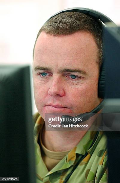 An Australian soldier sits at his computer situated in the command centre of the Urban Operations Training Facility during the combined urban combat...
