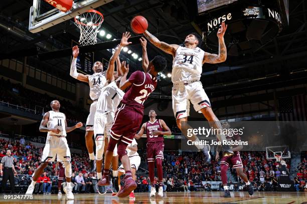 Jarron Cumberland and Kyle Washington of the Cincinnati Bearcats defend against Tyson Carter of the Mississippi State Bulldogs in the second half of...