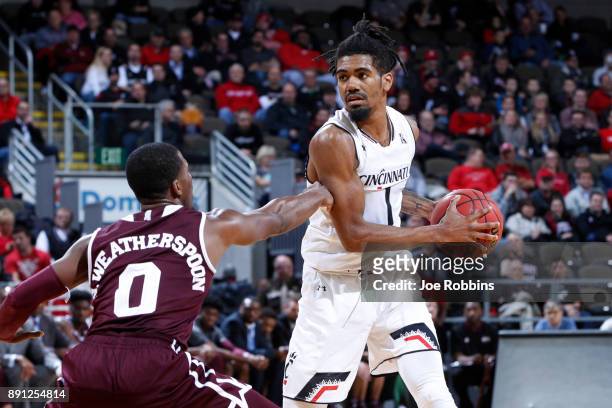 Jacob Evans of the Cincinnati Bearcats handles the ball against Nick Weatherspoon of the Mississippi State Bulldogs in the second half of a game at...