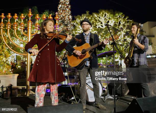 Ami Kozak, Dov Rosenblatt and Dubid Swirsky of the band Distant Cousins perform at the Village Synagogue and Emmanuelle Chriqui Host Menorah Lighting...