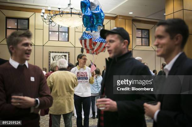 Attendees gather to watch results come in during an election night party for Doug Jones, Democratic U.S. Senate candidate from Alabama, in...