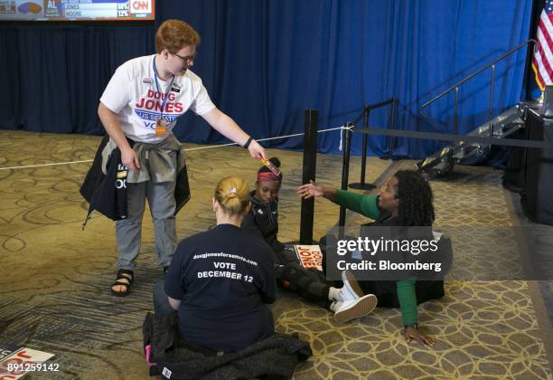 Attendees gather to watch results come in during an election night party for Doug Jones, Democratic U.S. Senate candidate from Alabama, in...