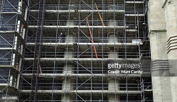 Stonemason Matthew Barton walks among the scaffold on the side of the north transept at Salisbury Cathedral as part of a on-going programme of vital...
