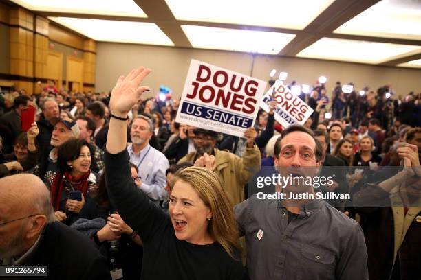 Supporters of democratic U.S. Senator candidate Doug Jones celebrate as Jones is declared the winner during his election night gathering the Sheraton...