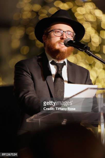 Rabbi Zamy Fogelman speaks onstage at the Village Synagogue and Emmanuelle Chriqui Host Menorah Lighting Ceremony at The Grove on December 12, 2017...