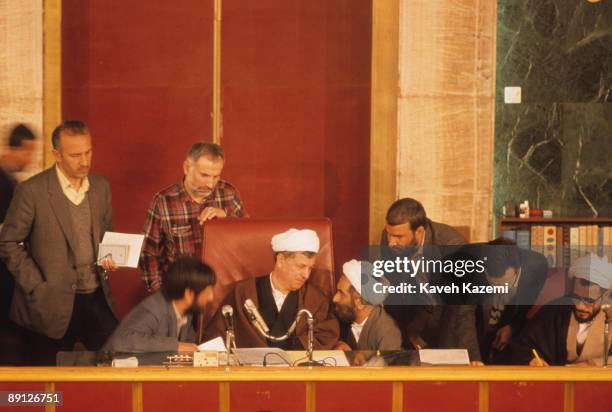 The Speaker of the Iranian parliament Ayatollah Ali Akbar Hashemi Rafsanjani talks to a deputy during a public session at the Majlis Building,...