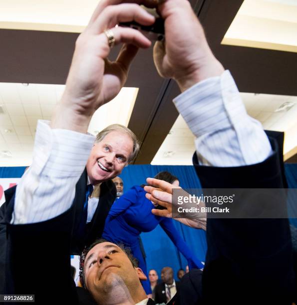 Alabama Democrat Doug Jones poses for a selfie as he celebrates his victory over Judge Roy Moore at the Sheraton in Birmingham, Ala., on Tuesday,...