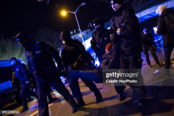 Policemen detain protester during blockade of Polish parliament organized by opposition group Obywatele RP in Warsaw on December 12, 2017.