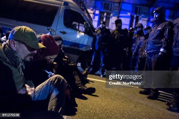 Protesters sit on the street during blockade of Polish parliament organized by opposition group Obywatele RP in Warsaw on December 12, 2017.