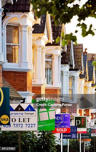 row of houses with for sale signs in front of them - pantövertagande bildbanksfoton och bilder