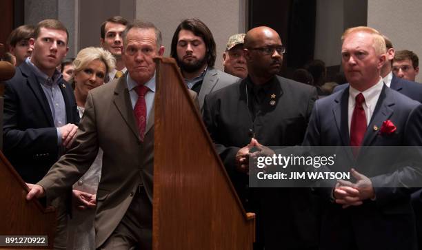 Republican Senatorial candidate Roy Moore stands off stage with members of his staff before addressing his supporters in Montgomery, Alabama, on...