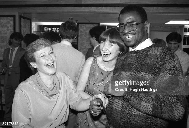 Paul Canoville with two female supporters at the Supporters Club Christmas party in December 1984 at Stamford Bridge, in London.