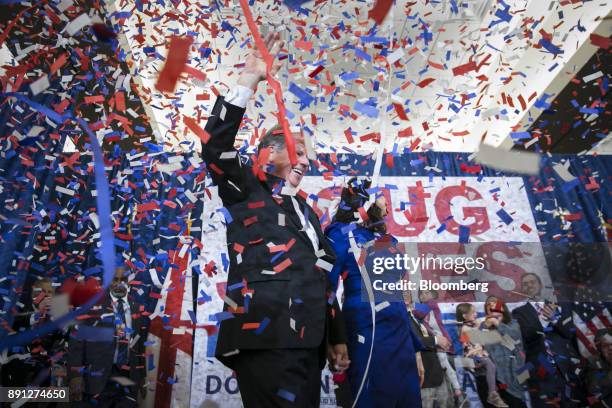 Confetti falls as Senator-elect Doug Jones, a Democrat from Alabama, left, and wife Louise Jones greet the audience at an election night party in...