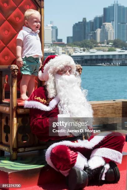 Santa Claus poses for photos with children at Luna Park on December 13, 2017 in Sydney, Australia. Luna Park has pulled some strings in the Northern...