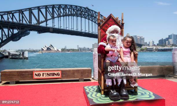 Santa Claus poses for photos with children at Luna Park on December 13, 2017 in Sydney, Australia. Luna Park has pulled some strings in the Northern...