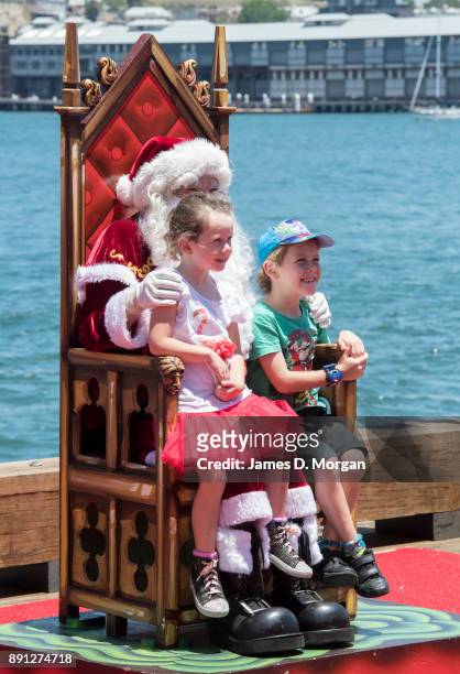 Santa Claus poses for photos with children at Luna Park on December 13, 2017 in Sydney, Australia. Luna Park has pulled some strings in the Northern...