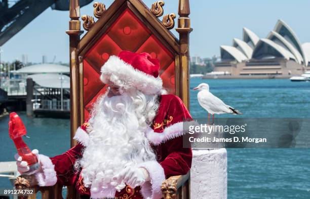 Santa Claus uses a water spray fan to keep cool in the hot summer sunshine at Luna Park on December 13, 2017 in Sydney, Australia. Luna Park has...