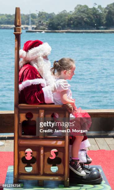 Santa Claus poses for photos with children at Luna Park on December 13, 2017 in Sydney, Australia. Luna Park has pulled some strings in the Northern...