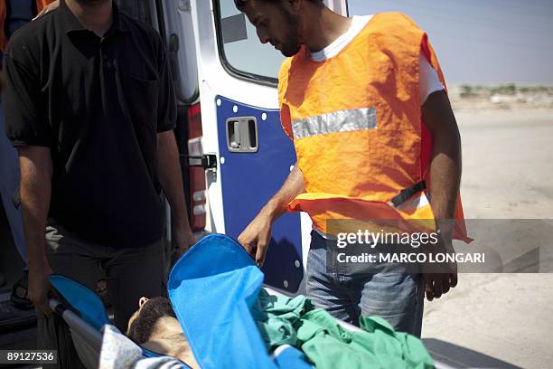 The body of Ahmad al-Semri is transferred to a Palestinian ambulance at the Gaza Strip side of the Erez Crossing on July 21, 2009 after it was...