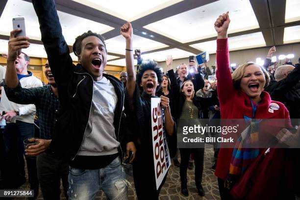 Supporters of Alabama Democrat Doug Jones celebrate his victory over Judge Roy Moore at the Sheraton in Birmingham, Ala., on Tuesday, Dec. 12, 2017....