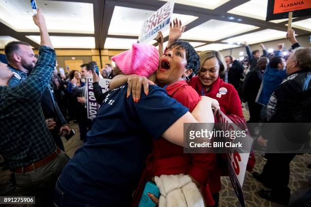 Supporters of Alabama Democrat Doug Jones celebrate his victory over Judge Roy Moore at the Sheraton in Birmingham, Ala., on Tuesday, Dec. 12, 2017....