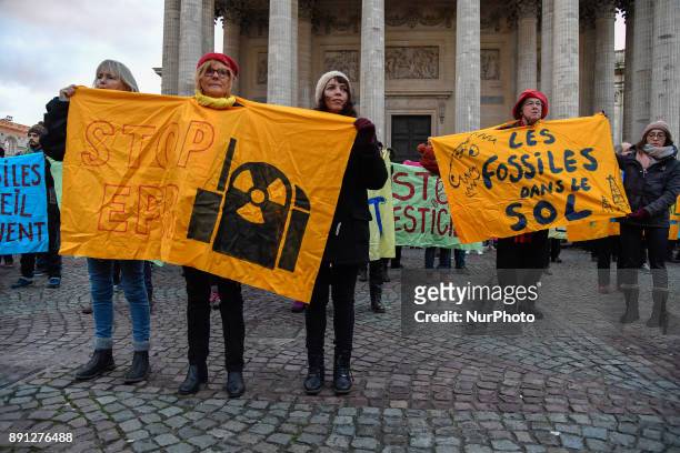 People take part in a demonstration called by NGO's outside the Pantheon in Paris on December 12, 2017 on the sidelines of the 'One Planet Summit -...