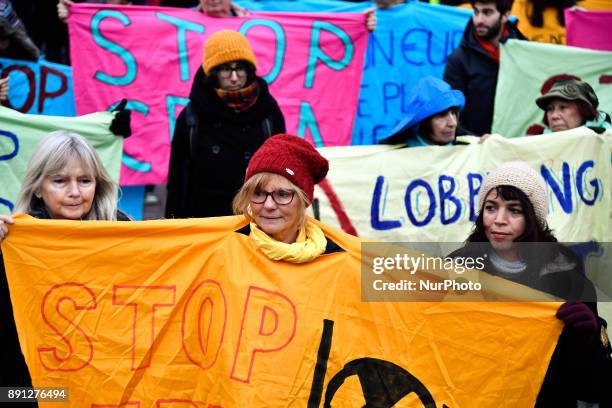 People take part in a demonstration called by NGO's outside the Pantheon in Paris on December 12, 2017 on the sidelines of the 'One Planet Summit -...