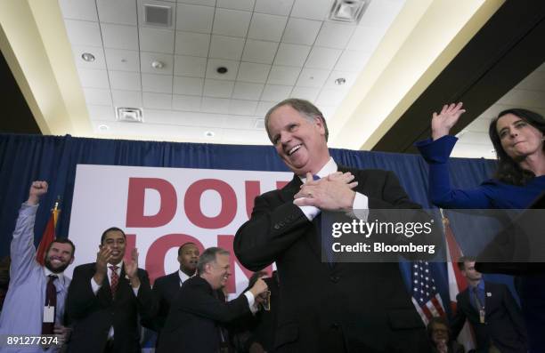 Senator-elect Doug Jones, a Democrat from Alabama, center, and wife Louise Jones, right, greet the audience at an election night party in Birmingham,...