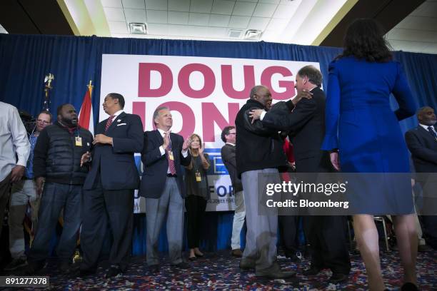 An attendee greets Senator-elect Doug Jones, a Democrat from Alabama, third right, at an election night party in Birmingham, Alabama, U.S., on...