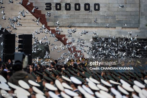 Doves are released during a memorial ceremony at the Nanjing Massacre Memorial Hall on the second annual national day of remembrance to commemorate...
