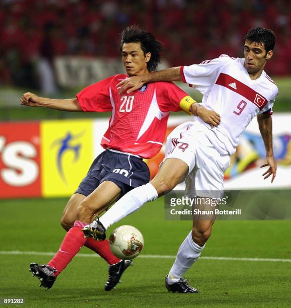 Hakan Sukur of Turkey reaches the ball ahead of Myung Bo Hong of South Korea during the FIFA World Cup Finals 2002 Third Place Play-Off match played...