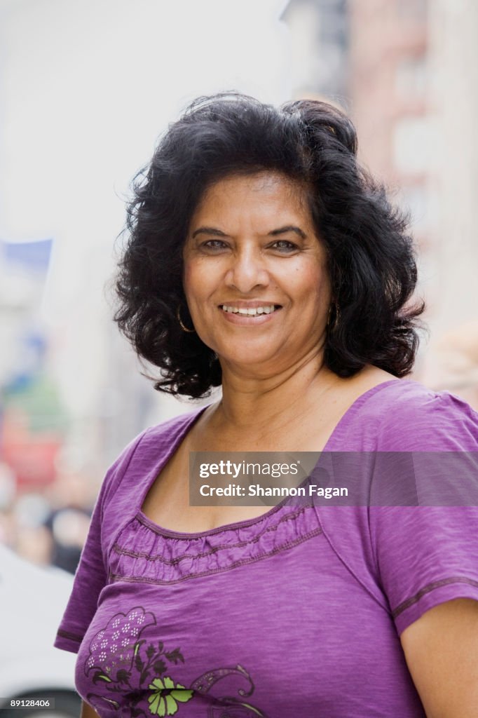 Mature Woman Standing on City Sidewalk 