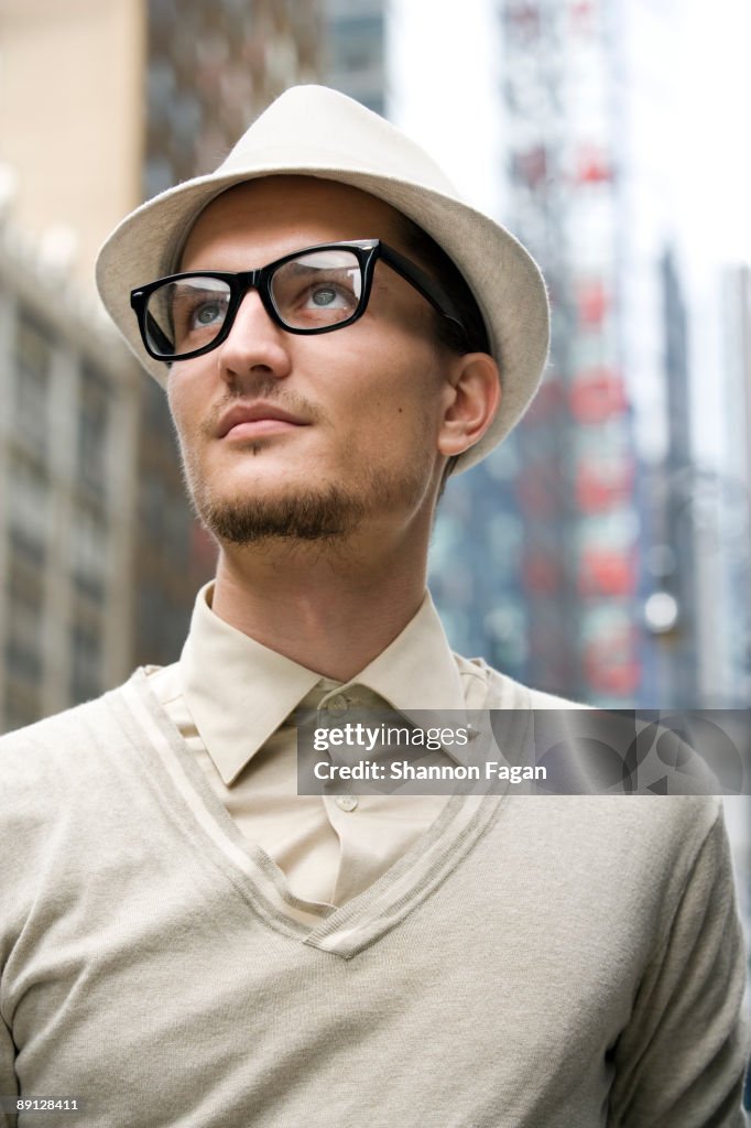 Young Man Gazing to Sky on City Streets