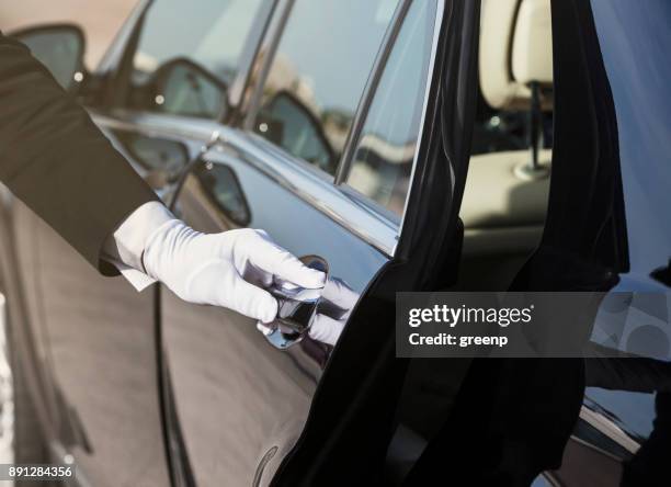 chauffeur opening car door, close-up of hand - door attendant imagens e fotografias de stock