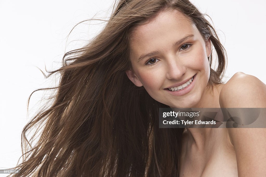 Portrait of woman smiling with hair blowing