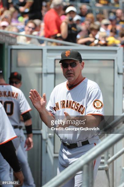 Manager Bruce Bochy of the San Francisco Giants looks on from the dugout during a game against the Pittsburgh Pirates at PNC Park on July 19, 2009 in...