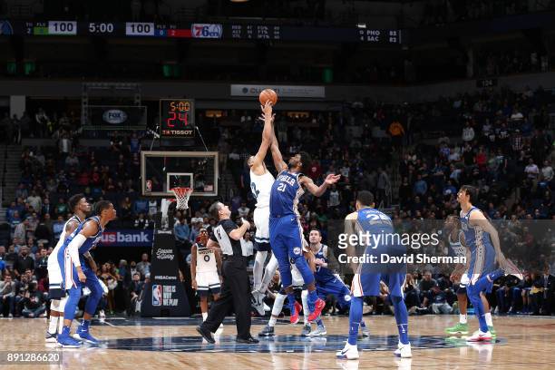 Karl-Anthony Towns of the Minnesota Timberwolves and Joel Embiid of the Philadelphia 76ers tipoff for overtime on December 12, 2017 at Target Center...