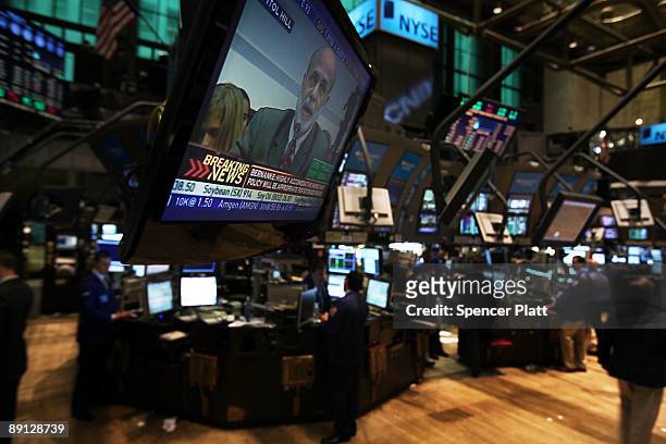 Traders work on the floor of the New York Stock Exchange during morning trading, as a television shows Federal Reserve Chairman Ben Bernanke...