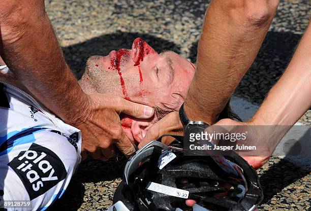Jens Voigt of Germany and team Saxo Bank lies injured on the ground after falling in the descend of the Col du Petit-Saint-Bernard during stage 16 of...