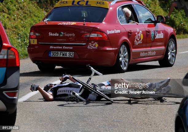 Jens Voigt of Germany and team Saxo Bank lies on the road after falling in the descend of the Col du Petit-Saint-Bernard during stage 16 of the 2009...