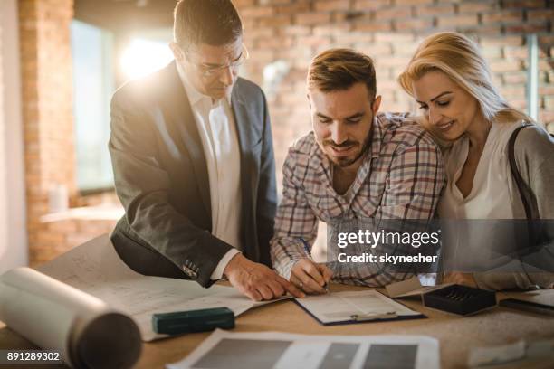 sign here and the apartment is yours! - couple signing stock pictures, royalty-free photos & images