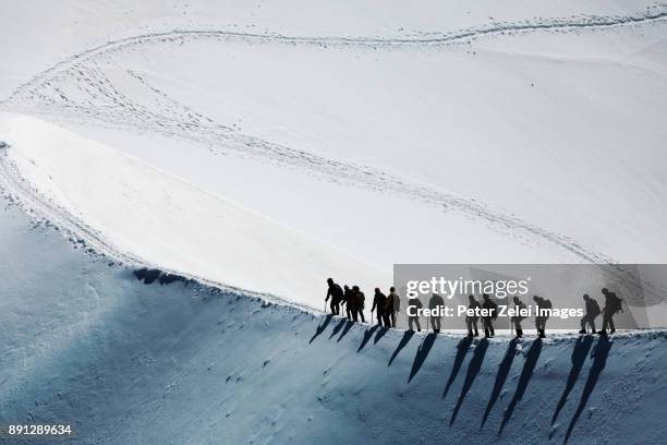 mountain climbers in the mont blanc massif - bergsteigen stock-fotos und bilder