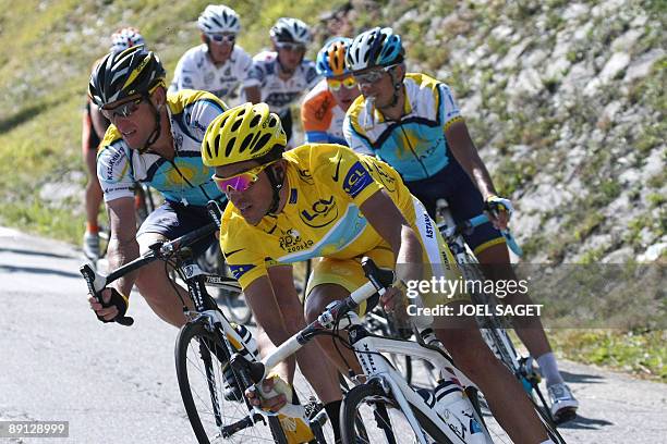 Yellow jersey of overall leader, 2007 Tour de France winner Alberto Contador of Spain rides with seven-time Tour de France winner and Kazakh cycling...