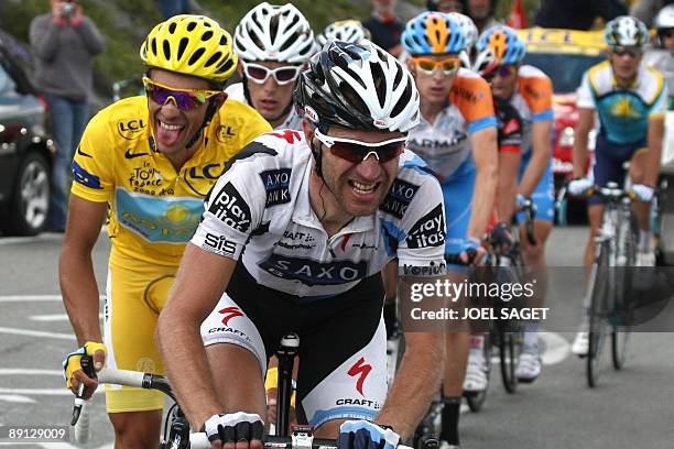 Yellow jersey of overall leader, 2007 Tour de France winner Alberto Contador of Spain rides with Danish cycling team Team Saxo Bank 's Jens Voigt of...